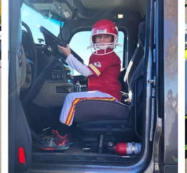 Children in Halloween costumes with trucks and vehicles