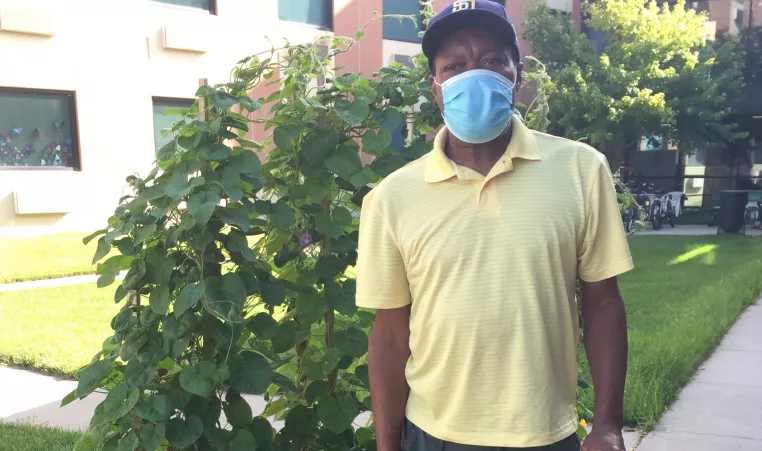 man wearing mask standing outside