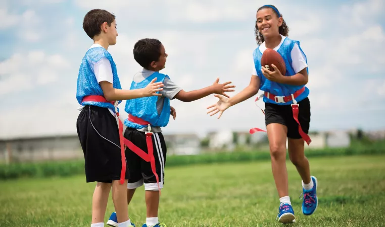 Three kids playing Y Flag Football